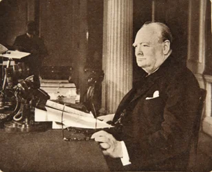 Advance, Britannia! Long live the cause of Freedom! God save the King!: Mr. Winston Churchill seated at the microphone on VE Day, when he announced to the nation that the war with Germany was at an end